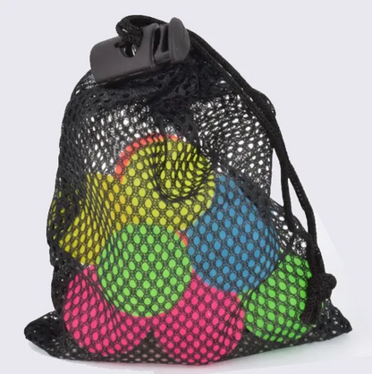 A black mesh drawstring bag with a black plastic clasp, containing several brightly colored round balls in yellow, blue, green, and pink, photographed on a light gray background.