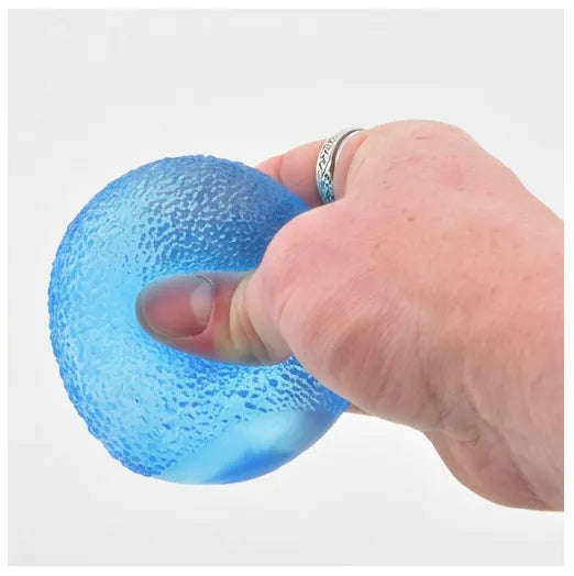 A hand squeezing a translucent blue textured stress ball against a plain white background.