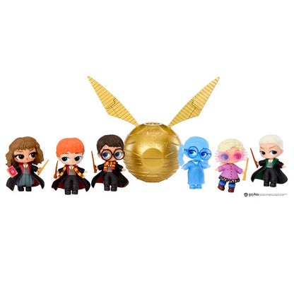 Set of Harry Potter-themed figurines with a golden ball and wands on a white background